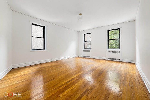 35-15 84th St Unit 2E, New York City, NY 11372 - empty room featuring radiator, light wood finished floors, and baseboards