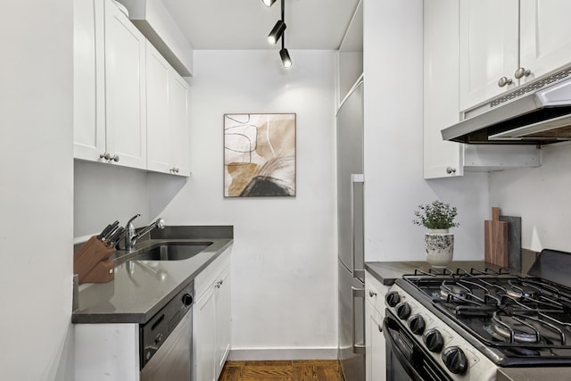 288 Lexington Ave Unit 6C, New York City, NY 10016 - kitchen featuring appliances with stainless steel finishes, a sink, under cabinet range hood, dark countertops, and white cabinets