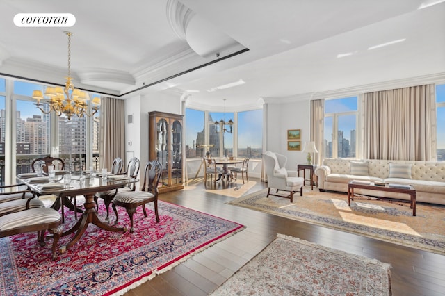 dining room featuring a chandelier, ornamental molding, a skyline view, and hardwood / wood-style floors