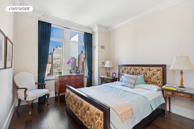 bedroom with ornamental molding, baseboards, and dark wood-style floors