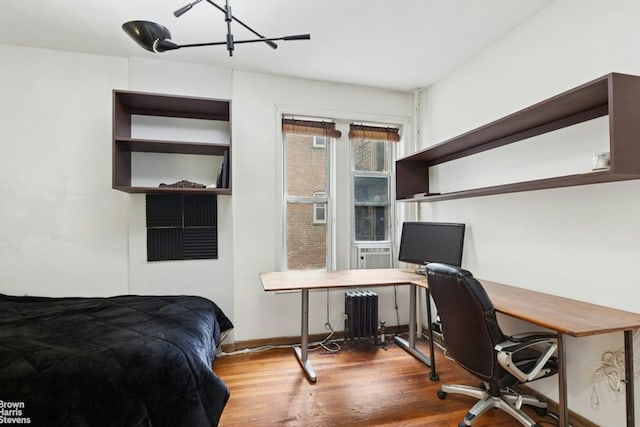 128 W 138th St Unit 3H, New York City, NY 10030 - bedroom with radiator, wood finished floors, and an office area