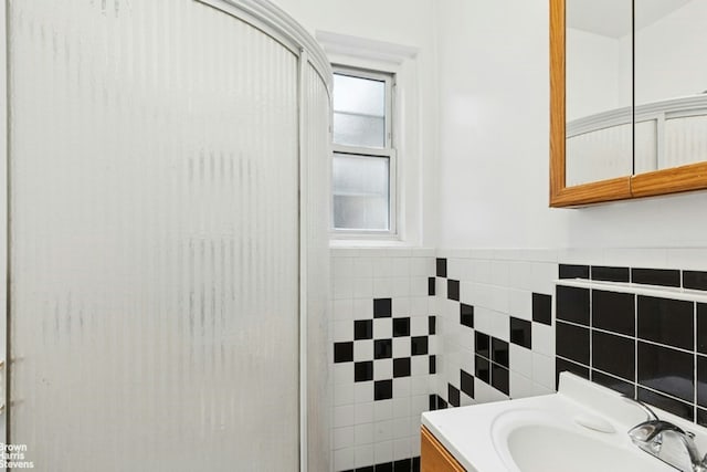 128 W 138th St Unit 3H, New York City, NY 10030 - bathroom with tile walls, vanity, and wainscoting