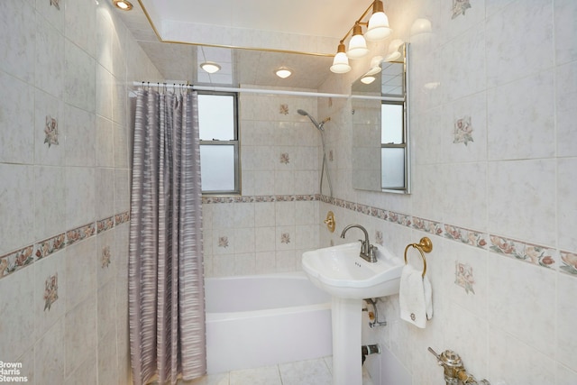225 E 76th St Unit 4A, New York City, NY 10021 - full bathroom featuring tile walls, healthy amount of natural light, shower / bathtub combination with curtain, and tile patterned floors