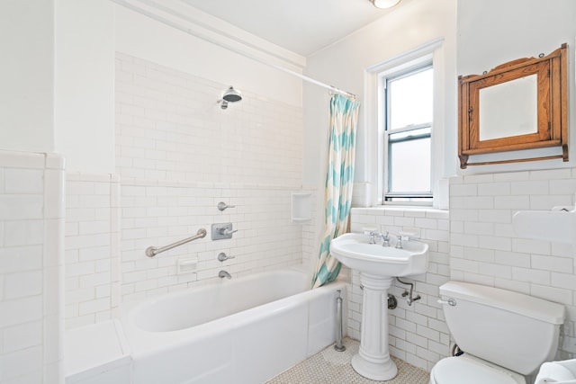 345 W 55th St Unit 9-Gh, New York City, NY 10019 - bathroom with shower / tub combo, tile walls, tile patterned floors, and wainscoting