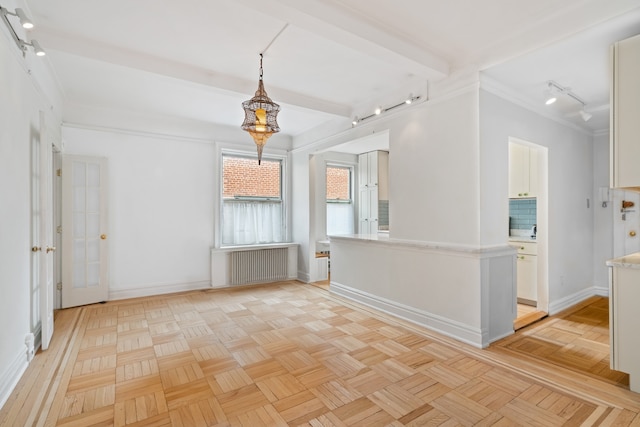 345 W 55th St Unit 9-Gh, New York City, NY 10019 - empty room featuring radiator, rail lighting, crown molding, and beam ceiling