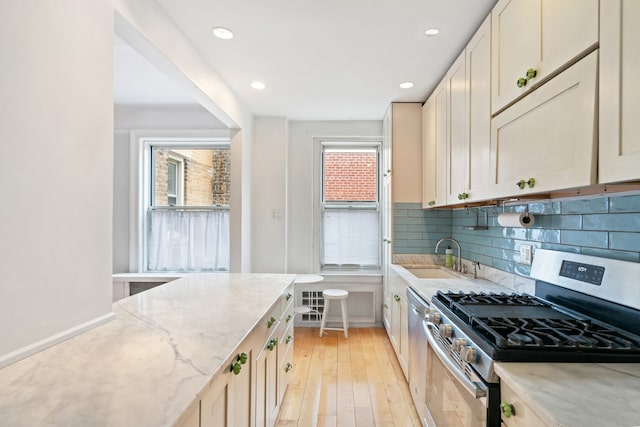 345 W 55th St Unit 9-Gh, New York City, NY 10019 - kitchen with appliances with stainless steel finishes, light wood-style floors, tasteful backsplash, light stone countertops, and recessed lighting