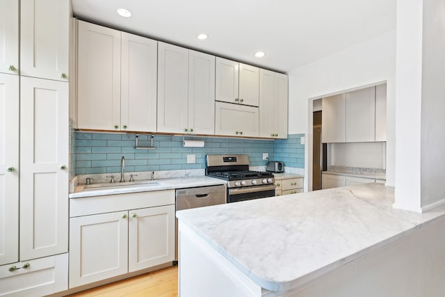 345 W 55th St Unit 9-Gh, New York City, NY 10019 - kitchen with appliances with stainless steel finishes, tasteful backsplash, light stone countertops, white cabinets, and recessed lighting