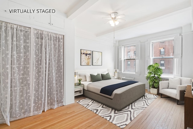 345 W 55th St Unit 9-Gh, New York City, NY 10019 - bedroom with hardwood / wood-style flooring, beamed ceiling, a wall mounted air conditioner, and ceiling fan