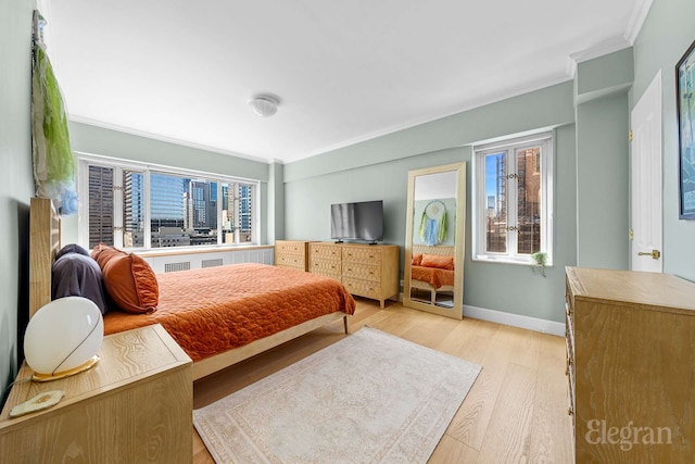 166 E 63rd St Unit 20A, New York City, NY 10065 - bedroom featuring ornamental molding, wood finished floors, and baseboards