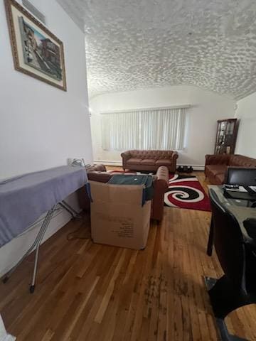 10567 Flatlands 7th St, New York City, NY 11236 - living room featuring vaulted ceiling and wood finished floors