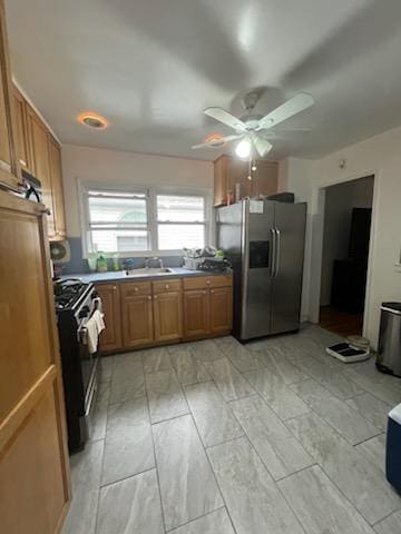 10567 Flatlands 7th St, New York City, NY 11236 - kitchen with stainless steel fridge with ice dispenser, gas range, a ceiling fan, and brown cabinetry