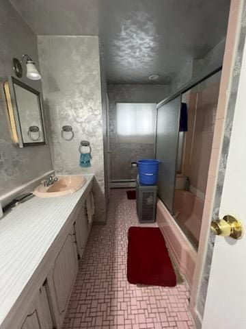 10567 Flatlands 7th St, New York City, NY 11236 - bathroom featuring vanity, bath / shower combo with glass door, and a baseboard heating unit