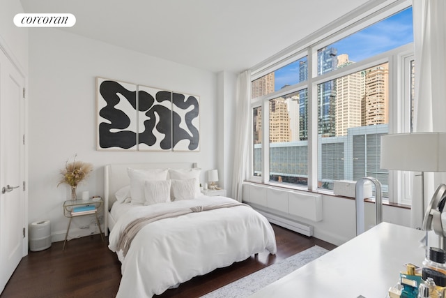 70 Little W St Unit 6J, New York City, NY 10280 - bedroom with dark wood-style flooring and a baseboard radiator