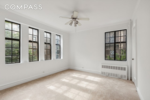 116 Pinehurst Ave Unit H32, New York City, NY 10033 - carpeted spare room featuring radiator heating unit, crown molding, baseboards, and a ceiling fan