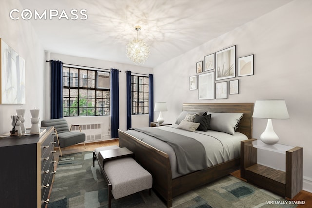 116 Pinehurst Ave Unit H32, New York City, NY 10033 - bedroom with radiator, a chandelier, and wood finished floors