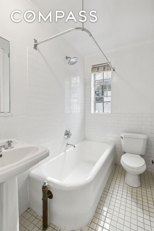 116 Pinehurst Ave Unit H32, New York City, NY 10033 - bathroom featuring tile walls, tile patterned floors, toilet, shower / tub combination, and a sink