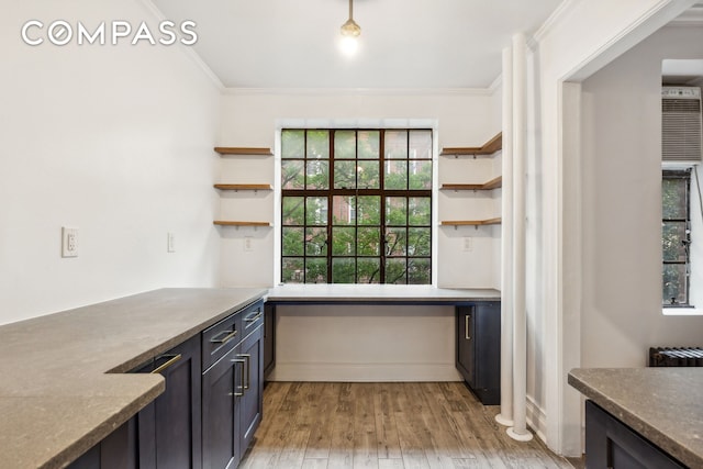116 Pinehurst Ave Unit H32, New York City, NY 10033 - kitchen with open shelves, ornamental molding, and light wood-type flooring