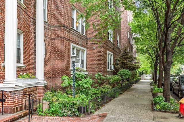 view of side of property featuring brick siding