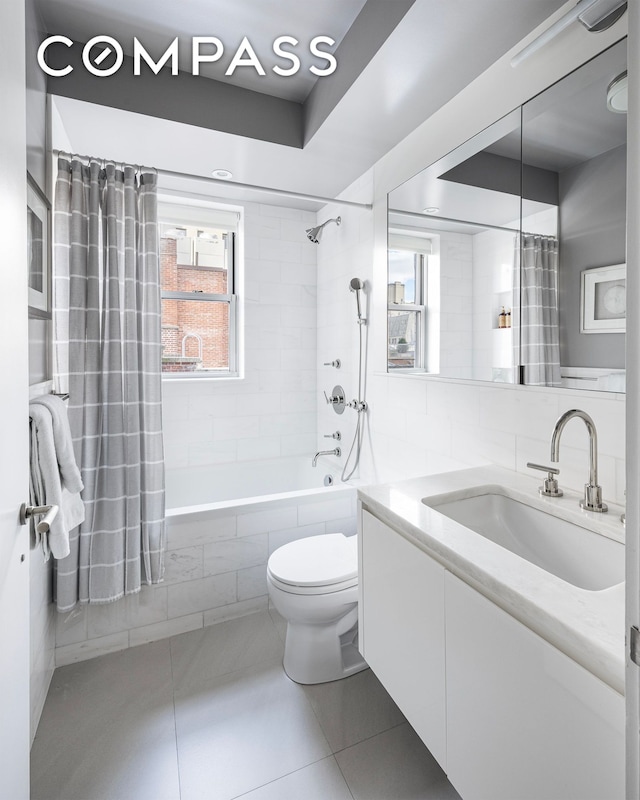 45 E 72nd St Unit 9Bc, New York City, NY 10021 - bathroom featuring vanity, tile patterned flooring, tiled shower / bath combo, and toilet