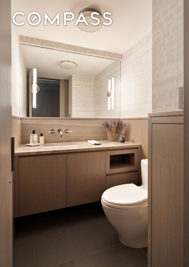 45 E 72nd St Unit 9Bc, New York City, NY 10021 - half bath with vanity, toilet, tile patterned flooring, and tasteful backsplash