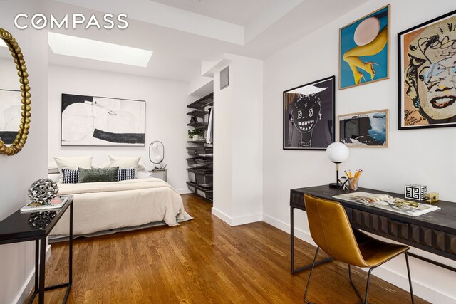 569 Carroll St Unit 9, New York City, NY 11215 - bedroom featuring a skylight, wood finished floors, baseboards, and a desk