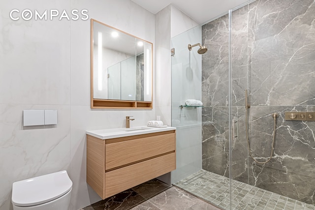 420 E 75th St Unit 3, New York City, NY 10021 - full bath with a marble finish shower, toilet, vanity, marble finish flooring, and tile walls