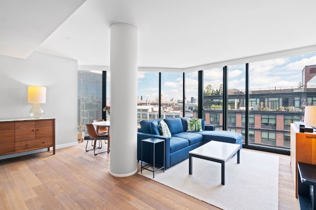 21-30 44th Dr Unit 7C, New York City, NY 11101 - living room with wood finished floors, floor to ceiling windows, and baseboards