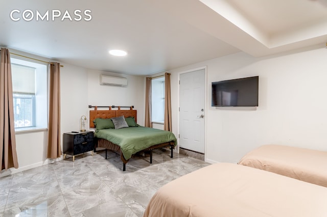 212 E 70th St Unit B, New York City, NY 10021 - bedroom featuring a wall mounted air conditioner and light marble finish flooring