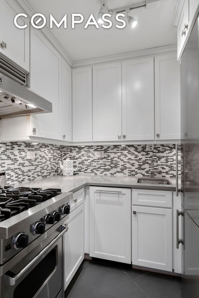 200 E 27th St Unit 2V, New York City, NY 10016 - kitchen with appliances with stainless steel finishes, dark tile patterned flooring, decorative backsplash, white cabinets, and ventilation hood