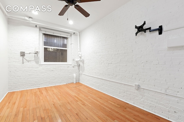 140 W 10th St Bte, Unit Bte, New York City, NY 10014 - spare room with brick wall, ceiling fan, and wood-type flooring