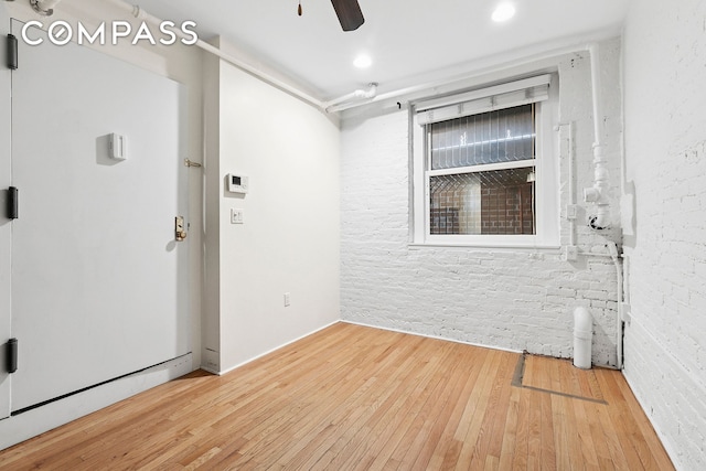 140 W 10th St Bte, Unit Bte, New York City, NY 10014 - spare room with hardwood / wood-style flooring, a ceiling fan, and brick wall