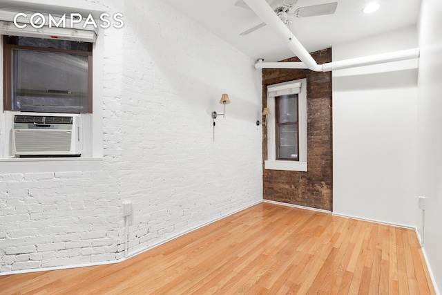 140 W 10th St Bte, Unit Bte, New York City, NY 10014 - empty room with ceiling fan, wood finished floors, cooling unit, and brick wall