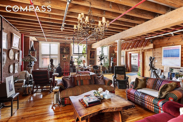 465 W Broadway Unit 4S, New York City, NY 10012 - living area with hardwood / wood-style flooring, ornate columns, beam ceiling, and a chandelier