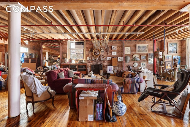 465 W Broadway Unit 4S, New York City, NY 10012 - living area with hardwood / wood-style floors, brick wall, and a fireplace