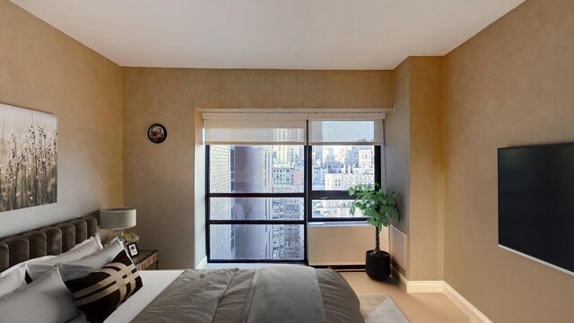 415 E 54th St Unit 19-G, New York City, NY 10022 - bedroom featuring baseboards