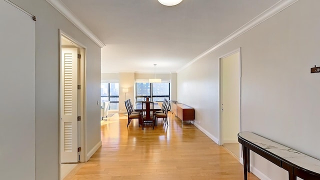 415 E 54th St Unit 19-G, New York City, NY 10022 - corridor featuring crown molding, light wood-style flooring, and baseboards