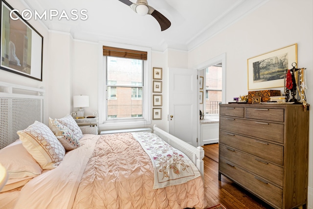 50 W 67th St Unit 4F, New York City, NY 10023 - bedroom with crown molding, dark wood-style flooring, multiple windows, and a ceiling fan