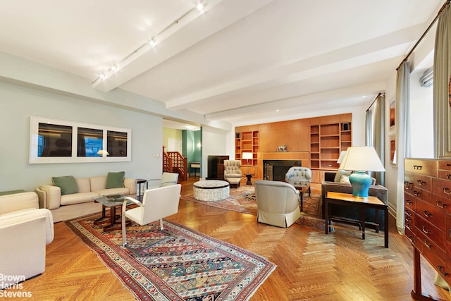 155 E 72nd St Unit 11/12A, New York City, NY 10021 - living room featuring beamed ceiling and a fireplace