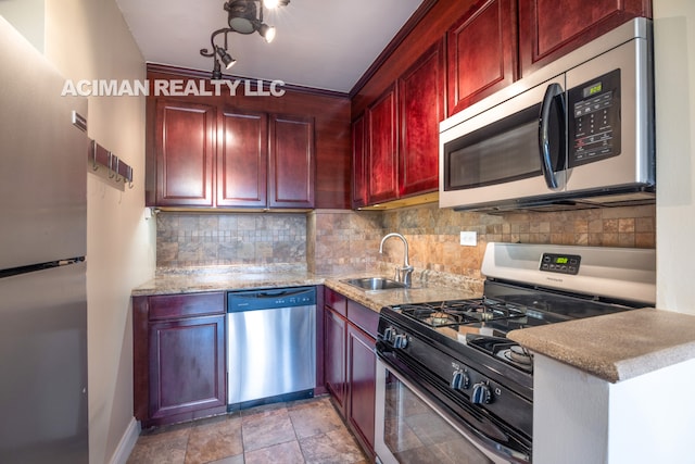 301 W 110th St Unit 6A, New York City, NY 10026 - kitchen featuring stainless steel appliances, reddish brown cabinets, a sink, decorative backsplash, and light stone counters