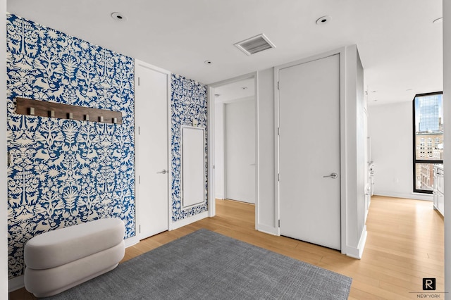 160 E 22nd St Unit 18-A, New York City, NY 10010 - bedroom featuring wood finished floors and wallpapered walls