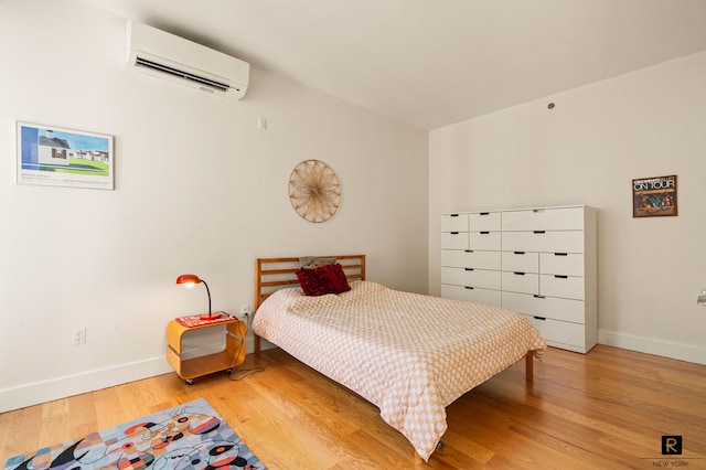 2100 Bedford Ave Unit 7-A, New York City, NY 11226 - bedroom with an AC wall unit, light wood finished floors, and baseboards