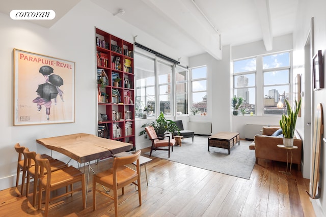 60 Broadway Unit 6G, New York City, NY 11249 - dining area featuring beamed ceiling, wood-type flooring, and a city view