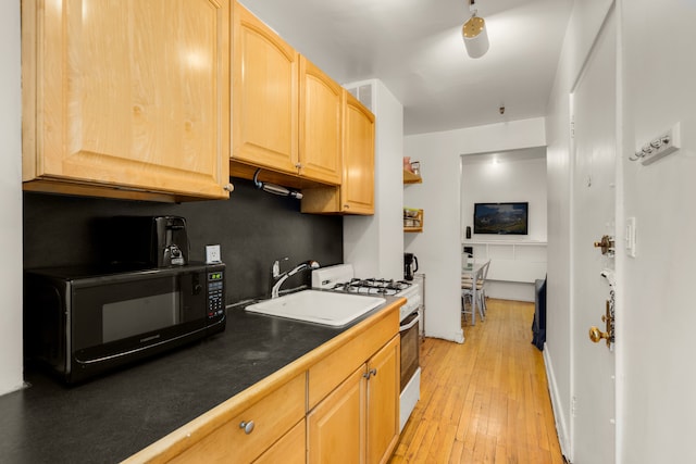 206 E 35th St Unit Th, New York City, NY 10016 - kitchen featuring black microwave, white gas range oven, light brown cabinets, a sink, and light wood-style flooring