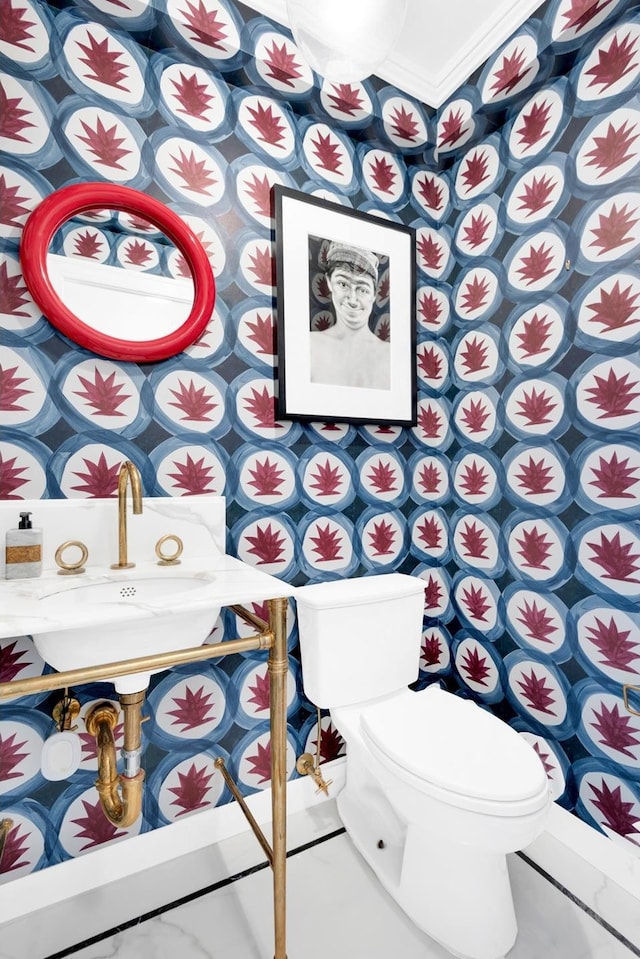 3 E 71st St Unit 10/11B, New York City, NY 10021 - bathroom featuring wallpapered walls, toilet, ornamental molding, and baseboards