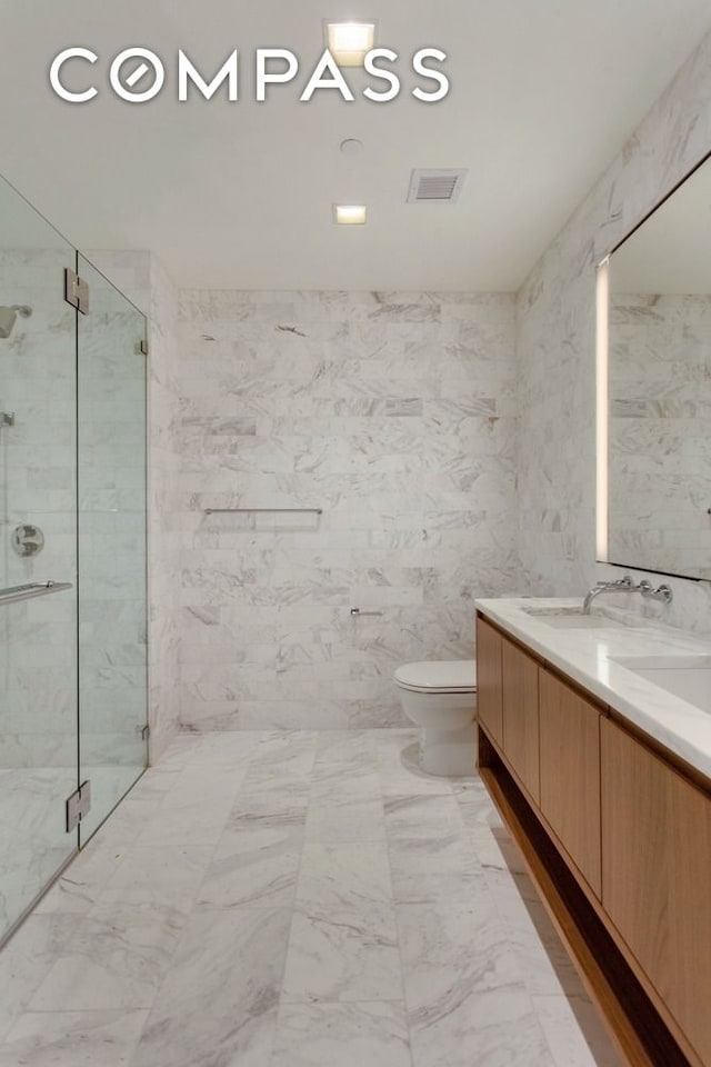 242 Broome St Unit 7D, New York City, NY 10002 - full bath with a marble finish shower, toilet, double vanity, and marble finish floors