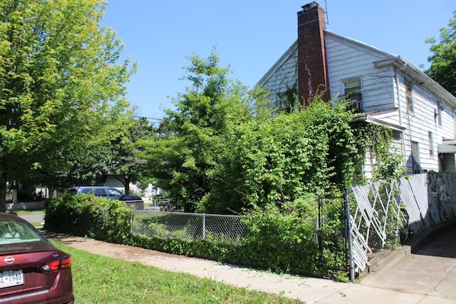 199-20 100th Ave, New York City, NY 11423 - view of home's exterior with a chimney