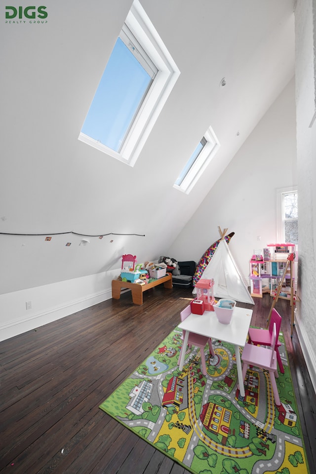 685 E 22nd St, New York City, NY 11210 - rec room featuring a skylight, vaulted ceiling, and wood finished floors
