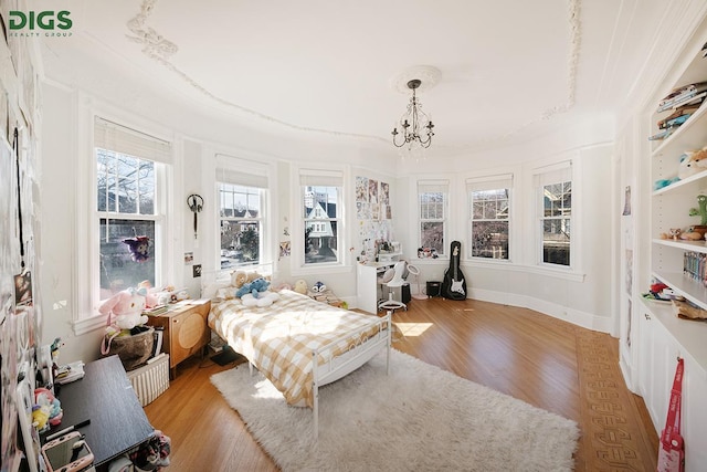 685 E 22nd St, New York City, NY 11210 - bedroom with light wood finished floors and a chandelier