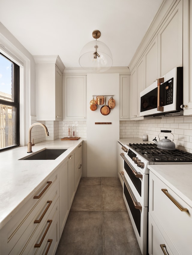 74 W 68th St Unit 7F, New York City, NY 10023 - kitchen with white appliances, a sink, and decorative backsplash