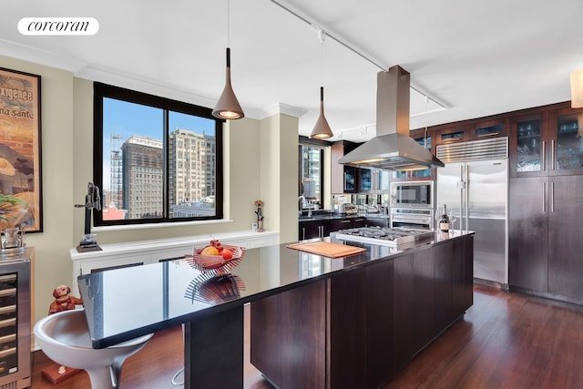 280 Park Ave S Unit 18Ef, New York City, NY 10010 - kitchen with built in appliances, island exhaust hood, dark wood-type flooring, beverage cooler, and healthy amount of natural light